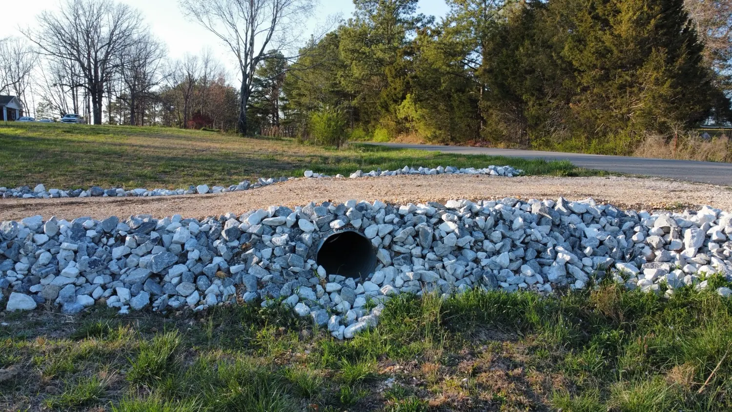 A driveway culvert lined with rip-rap stone
